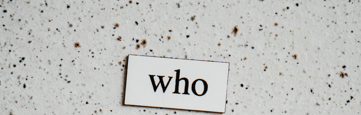 the word 'who' typed up in black on a small white tile